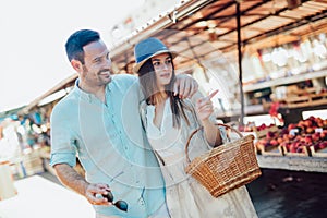 Young couple buying fruits and vegetables in a market