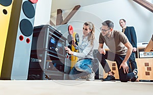 Young couple buying high-end stereo equipment in store