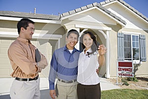 Young couple buying house holding keys photo