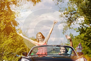 Young couple with cabriolet car in spring