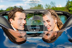 Young couple with cabriolet in summer on day trip