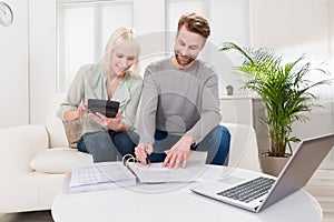 Young Couple Calculating Budget