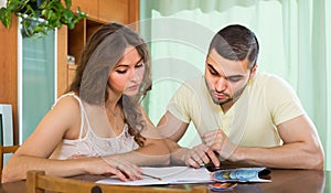 Young couple calculating budget