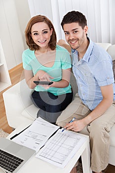 Young couple calculating budget