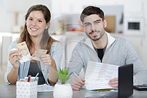 Young couple calculating taxes at home