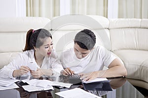 Young couple calculating their household finance