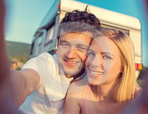 Young couple with a camper van