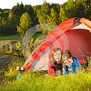 Young couple camping lying in tent