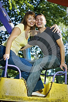 Young couple on the carousel