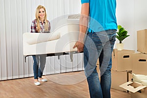 Young couple carrying couch