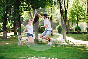 A young couple celebrate victory playing tic-tac-toe in the park.