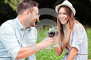 Young couple celebrating anniversary or birthday with a wine toast