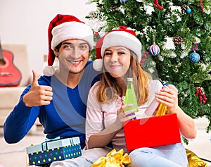 Young couple celebrating christmas at home