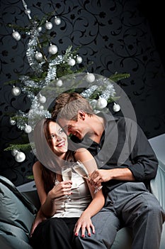 Young couple with champagne on Christmas