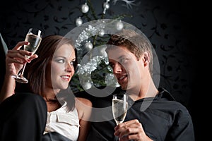 Young couple with champagne on Christmas