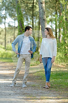 young couple chatting while walking along country path