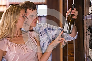Young couple chooses wine