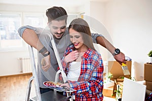 Young Couple Choosing Colors for Painting their Home