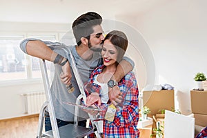 Young Couple Choosing Colors for Painting their Home