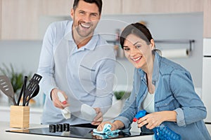 young couple cleaning cleaning modern kitchen