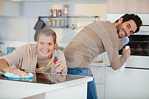 young couple cleaning cleaning modern kitchen