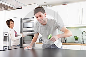 Young Couple Cleaning Modern Kitchen