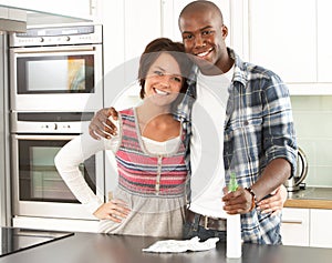 Young Couple Cleaning Modern Kitchen