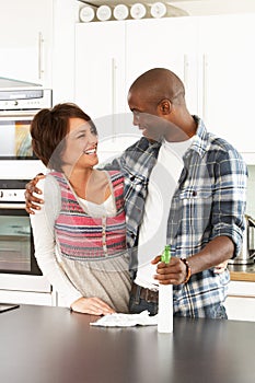 Young Couple Cleaning Modern Kitchen