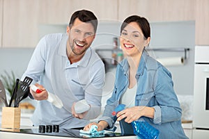 young couple cleaning modern kitchen