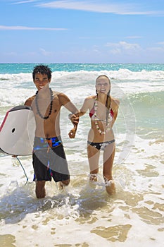 Young couple comes out of the ocean