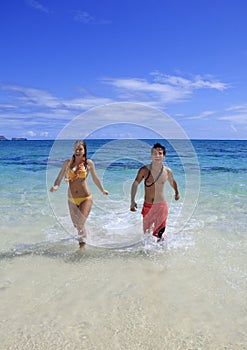 Young couple comes out of the ocean