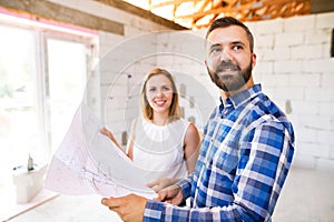 Young couple at the construction site.