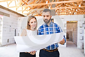 Young couple at the construction site.