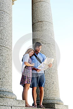 Young couple consults a map while on holiday photo