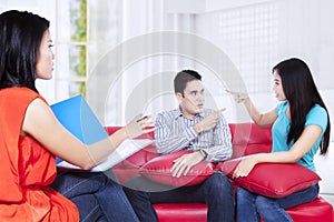 Young couple consults talking to psychologist