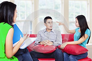 Young couple consults talking to psychologist