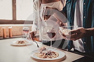 Young Couple Cooking Dinner and Drink Red Wine.