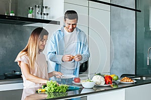 Young couple cooking a vegetarian breakfast