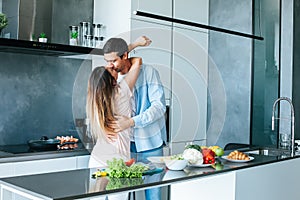 young couple cooking a vegetarian breakfast in the morning in a bright kitchen