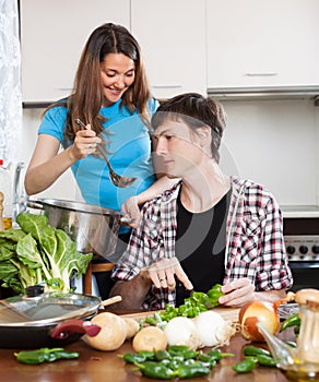 Young couple cooking veggy lunch