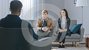 Young Couple on a Counseling Session with Psychotherapist. Back View of Therapist Taking Notes