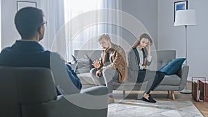 Young Couple on a Counseling Session with Psychotherapist. Back View of Therapist Taking Notes