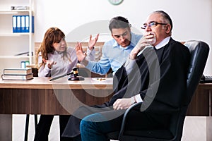 Young couple in the courthouse in divorce concept