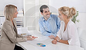 Young couple customers and adviser or agent talking about finance and insurance. photo