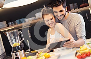 Young couple cutting fruit in the kitchen