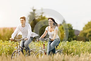 Young couple cycling with bicycle in summer