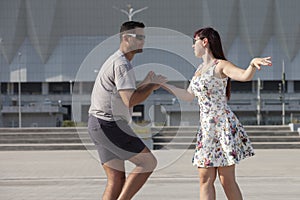 Young couple dances Caribbean Salsa. Social activity concept