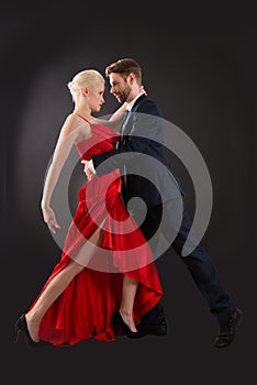 Young Couple Dancing On Black Background