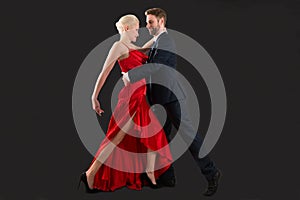 Young Couple Dancing On Black Background