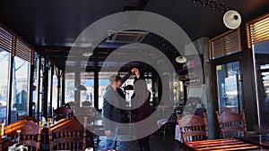 Young couple dancing in cafe on birthday party.